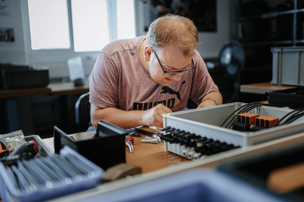 An employee assembling and mounting an assembly.