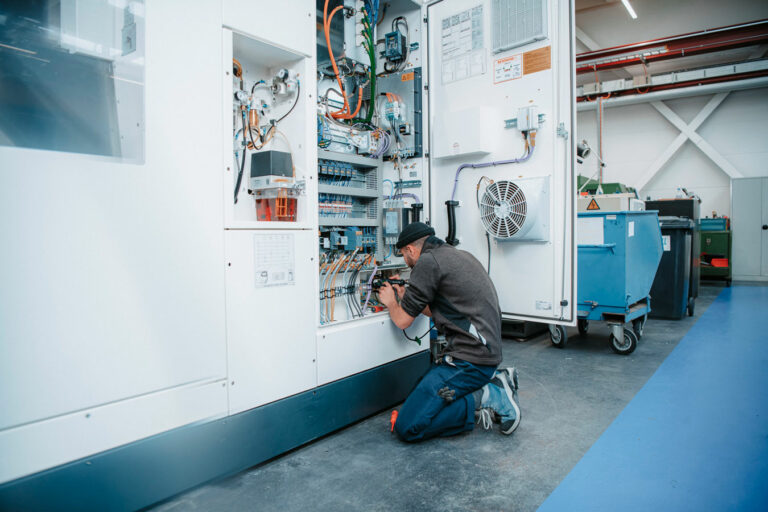 Man checks the switchgear